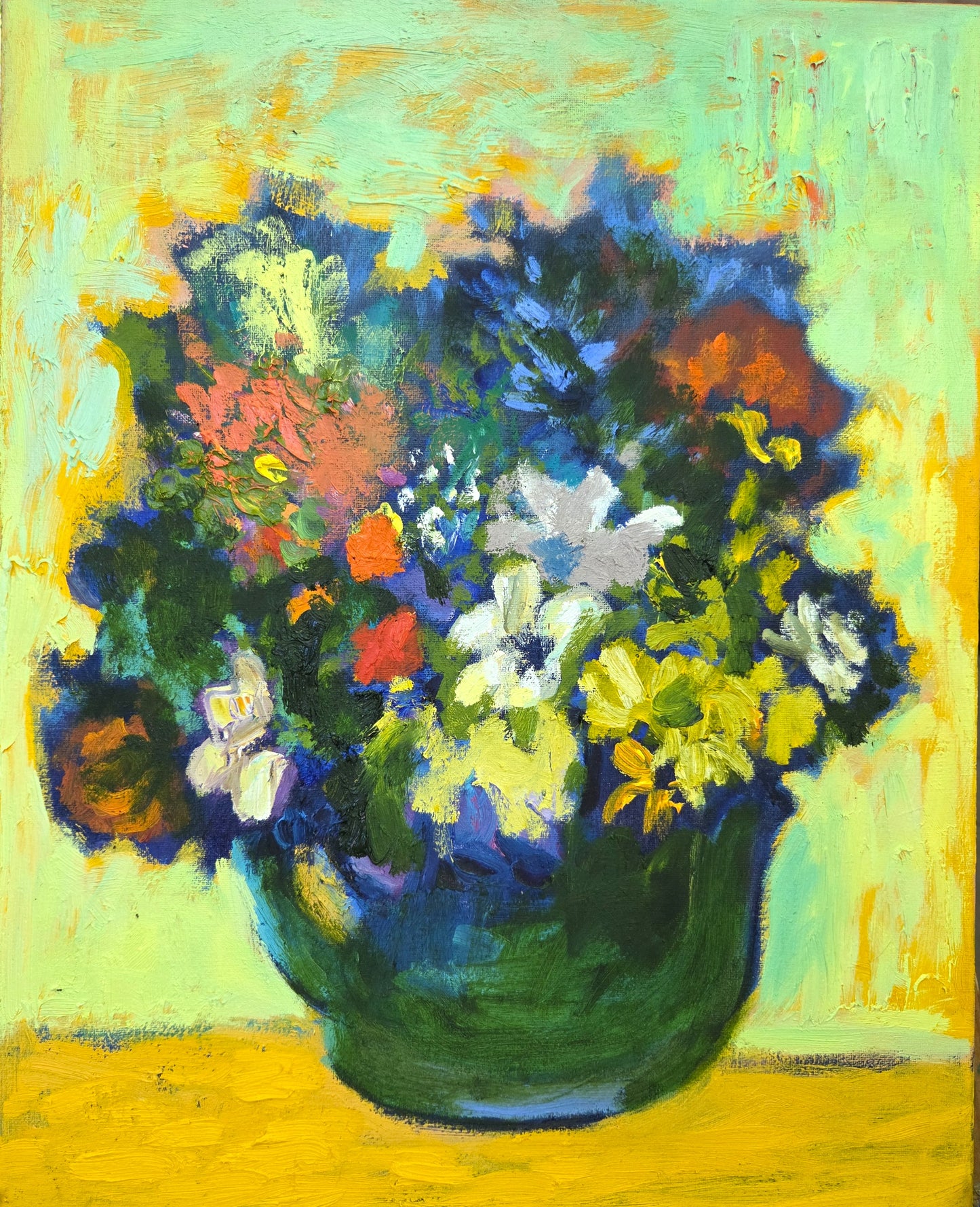 Colourful bouquet of flowers in a green teapot vase on a yellow background